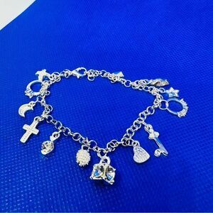 Silver toned charm bracelet with charms 813